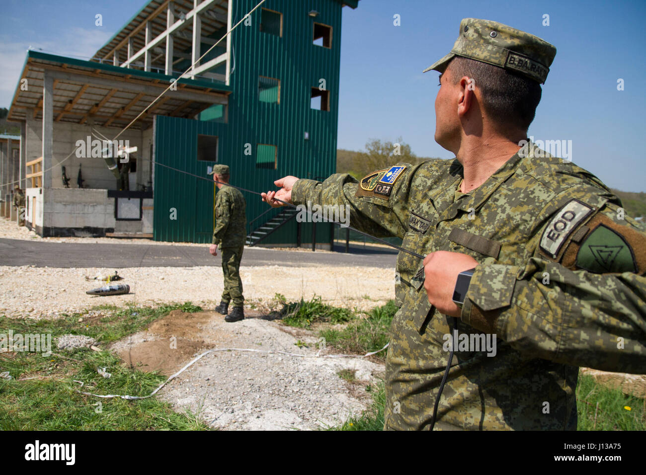Kosovo Security Force Explosive Ordnance Detachment team members pull a ...