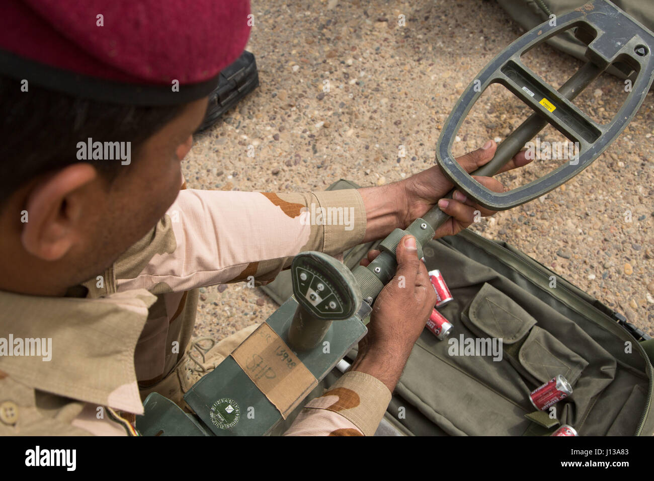An Iraqi security forces soldier assembles a mine detector during counter improvised explosive device training provided by British army trainers deployed in support of Combined Joint Task Force – Operation Inherent Resolve at Camp Taji, Iraq, April 12, 2017. This training is part of the overall Combined Joint Task Force – Operation Inherent Resolve building partner capacity mission by training and improving the capability of partnered forces fighting ISIS. CJTF-OIR is the global Coalition to defeat ISIS in Iraq and Syria.  (U.S. Army photo by Spc. Christopher Brecht) Stock Photo