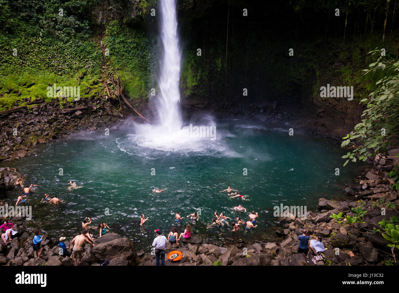 La Fortuna Waterfall, Costa Rica - March 31, 2014: People swimming at the pool of the La Fortuna Waterfall in Costa Rica. Stock Photo