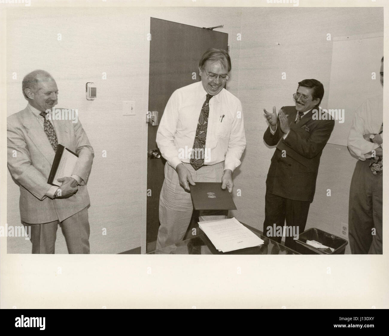 An individual receives a formal recognition award during a military or ...
