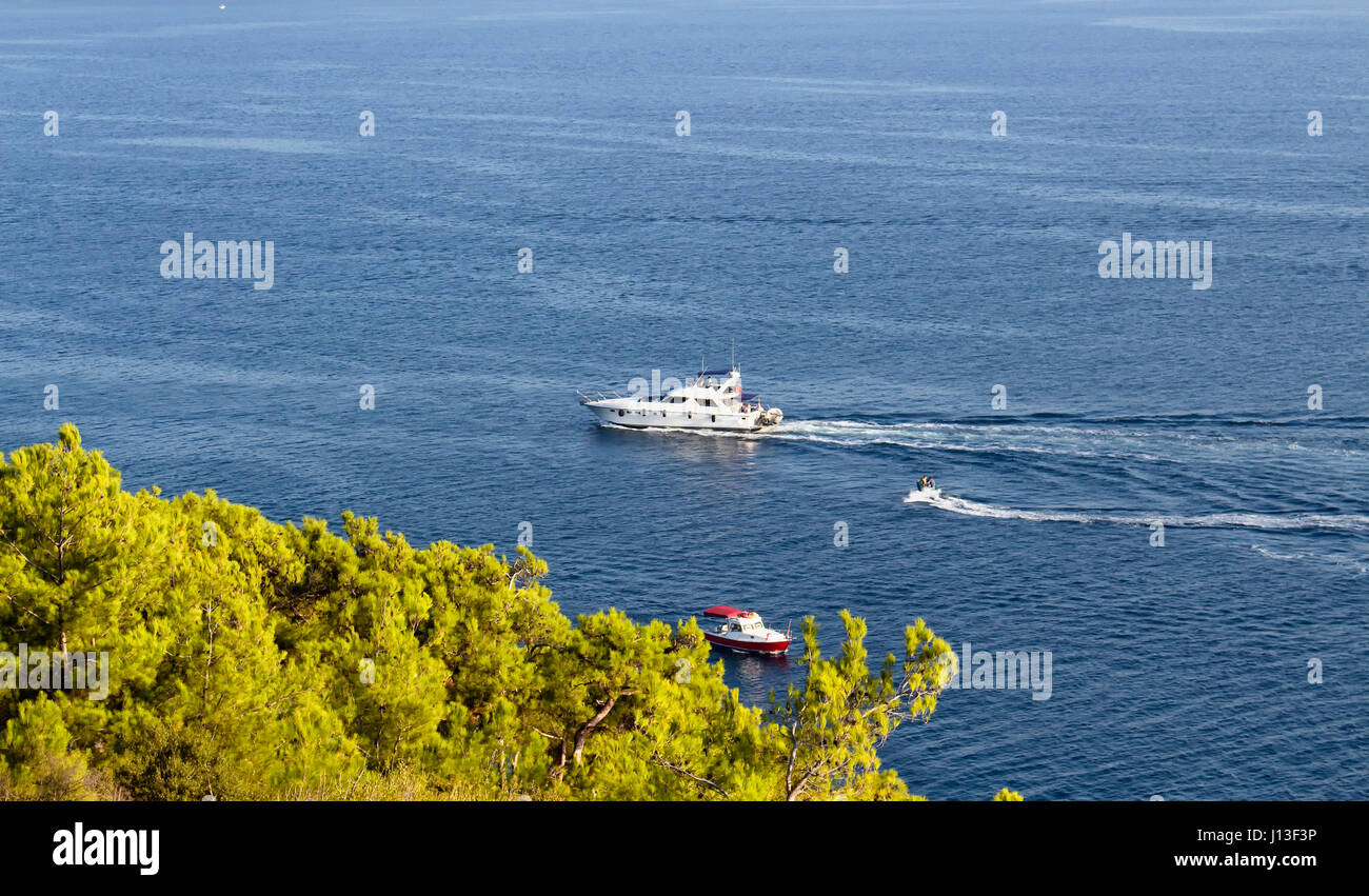Luxury yacht passes by Heybeliada which is one of Prince Islands on Marmara sea near Istanbul. Stock Photo