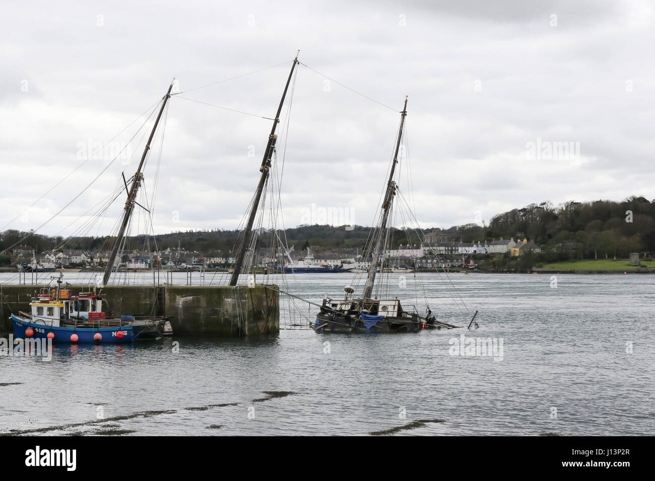 Sunken boat at quayside in Strangford Lough at Portaferry. Stock Photo