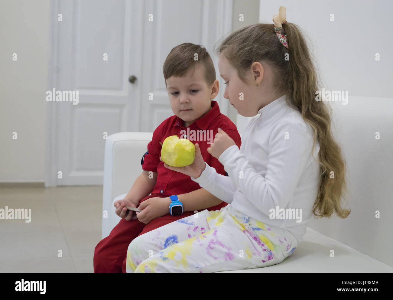 boy and girl sitting on the sofa and talking Stock Photo