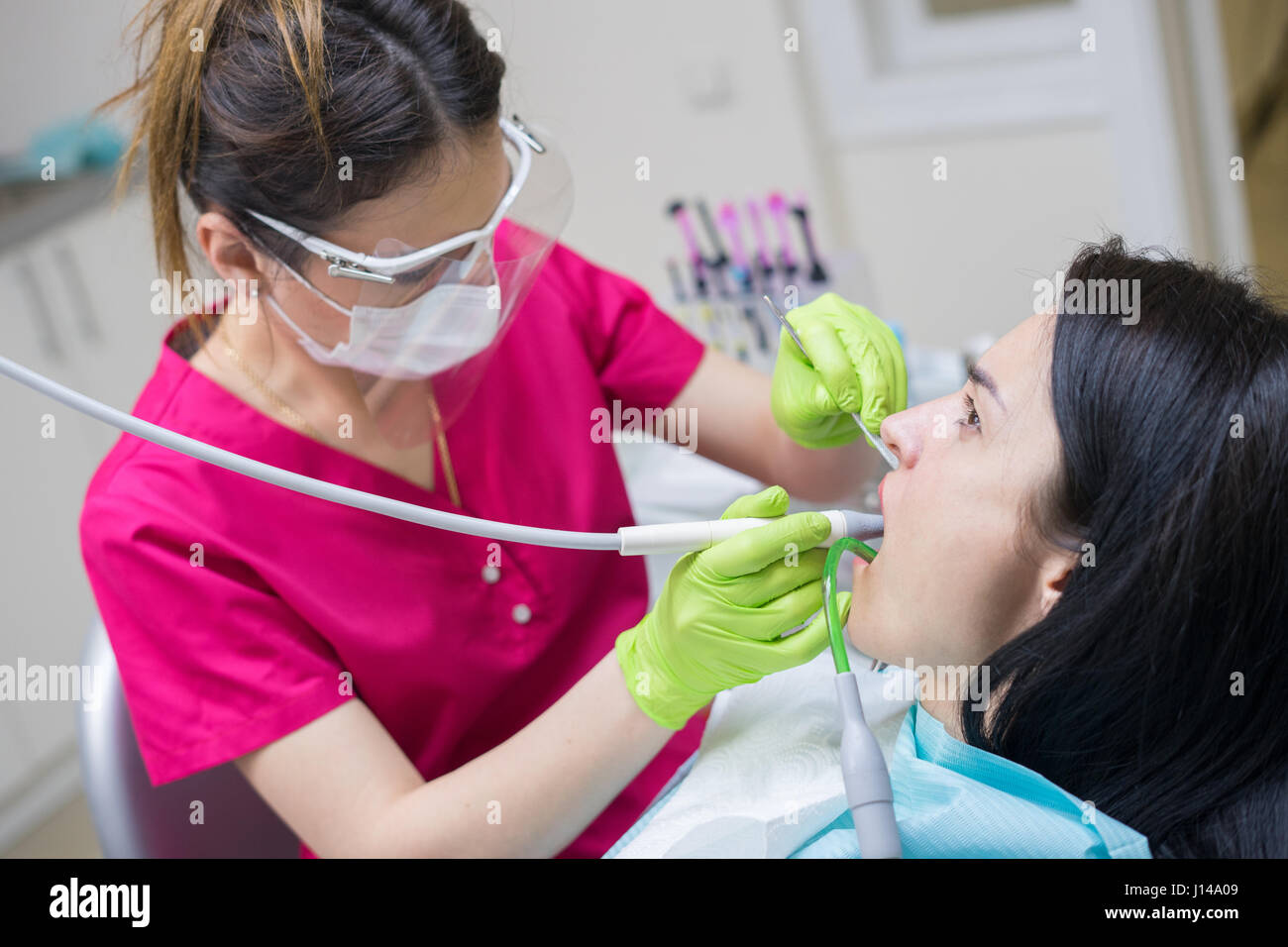 dentist cleaning teeth of woman Stock Photo Alamy