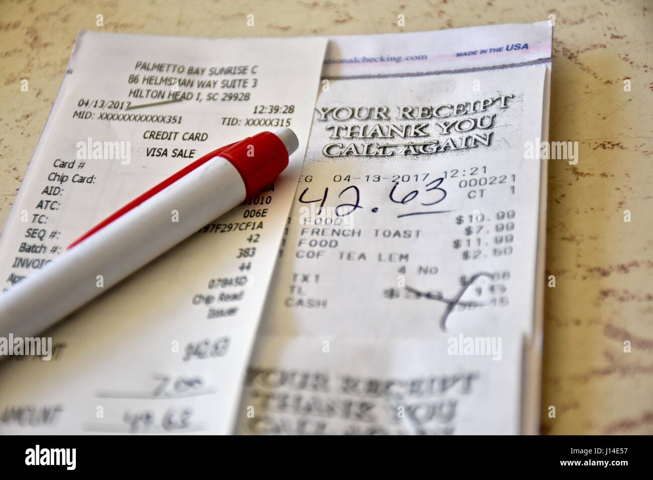 Restaurant tab receipt paid with tip included Stock Photo