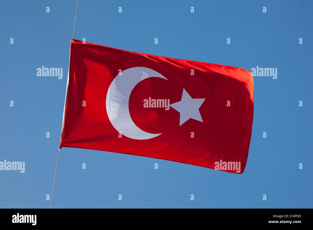 Turkish flag against blue sky Stock Photo