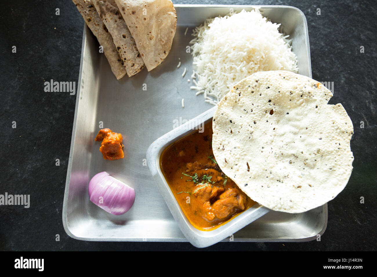 Chicken curry with rice,papad and roti Stock Photo