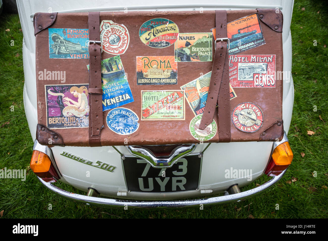 Luggage suitcase atop the boot of a vintage Fiat 500 car Stock Photo