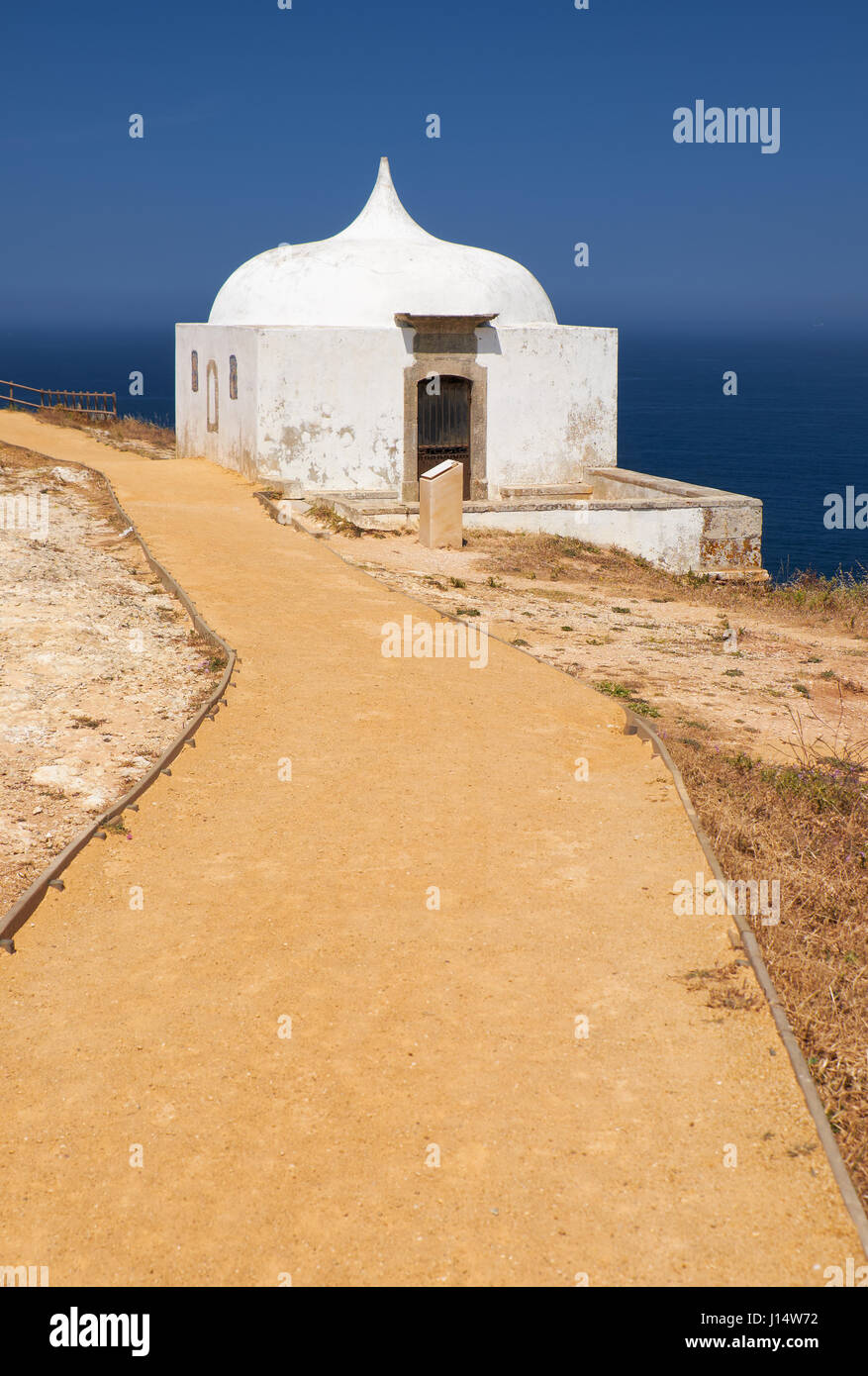 Path near Ermida da Memoria or Memory Chapel of Nossa Senhora do Cabo Church near cape Espichel in Sesimbra, Portugal Stock Photo
