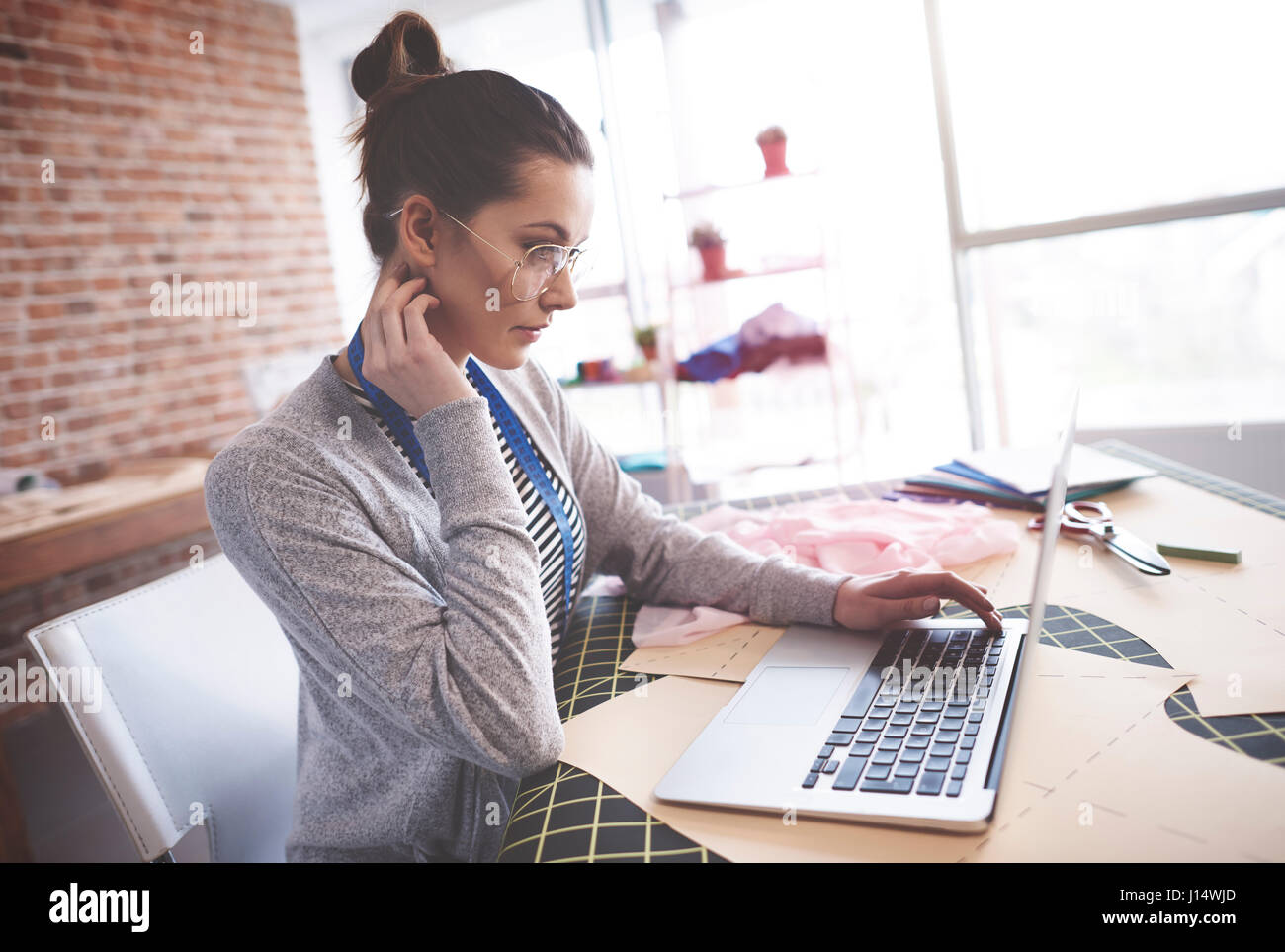 Clothing designer working on laptop Stock Photo Alamy