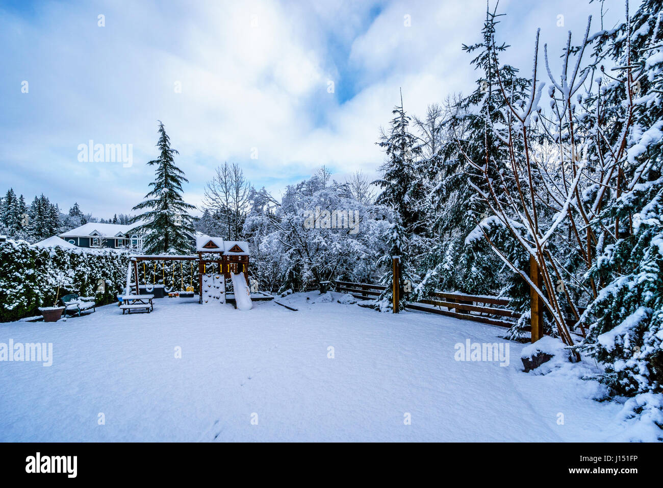 Playground in a winter landscape backyard set in the Fraser Valley of British Columbia, Canada Stock Photo