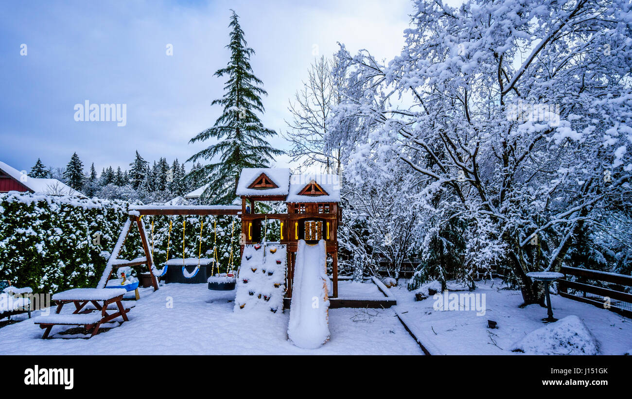Playground in a winter landscape backyard set in the Fraser Valley of British Columbia, Canada Stock Photo