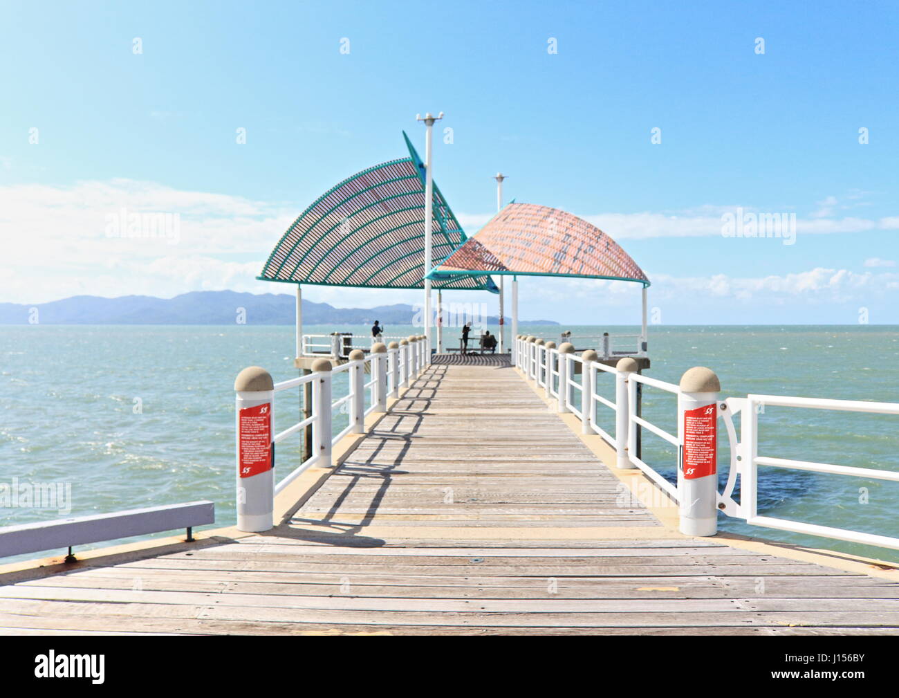 Townsville Strand Park and Beach and the Strand Jetty looking atmospheric on a hot Autumn day in the Australian tropics Stock Photo