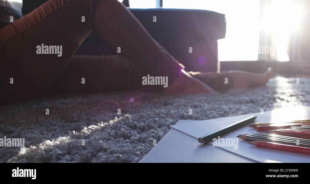 living room with coloring set for kids on floor Stock Photo - Alamy
