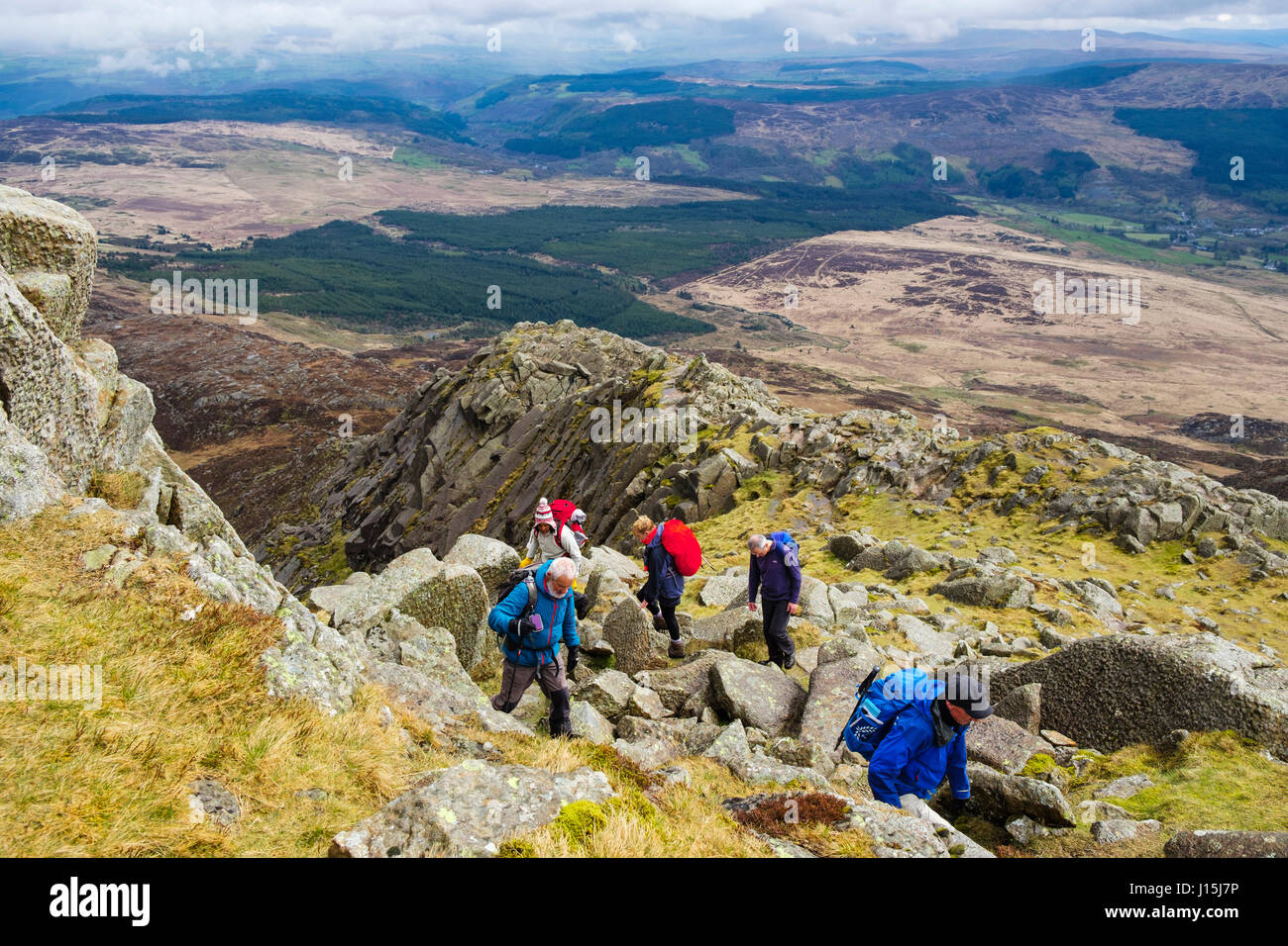 Hikers climbing on Daear Ddu east ridge on Carnedd Moel Siabod mountain in mountains of Snowdonia National Park. Capel Curig Conwy Wales UK Britain Stock Photo