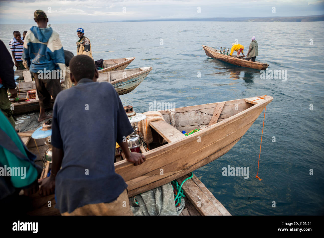 Fishermen launch canoes from the mother boat for the night fishing of sardines, locally known as buka-buka, on Lake Tanganyika, Zambia Stock Photo
