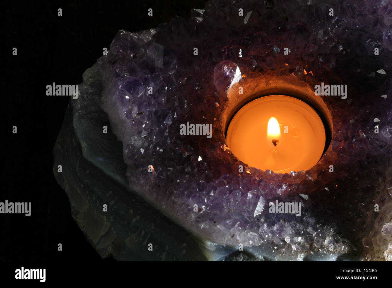 tea candle in amethyst geode Stock Photo Alamy