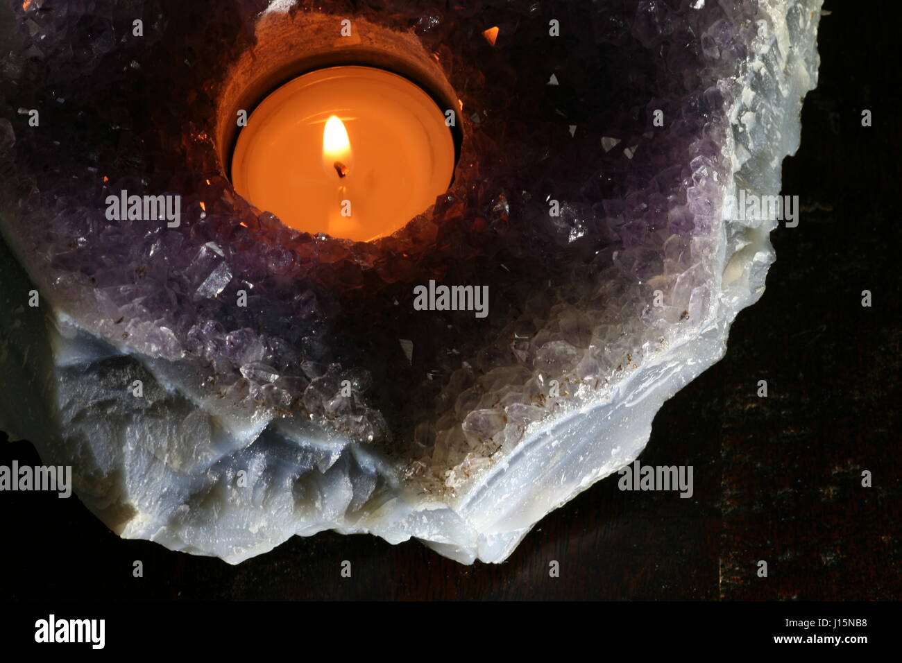 tea candle in amethyst geode Stock Photo Alamy