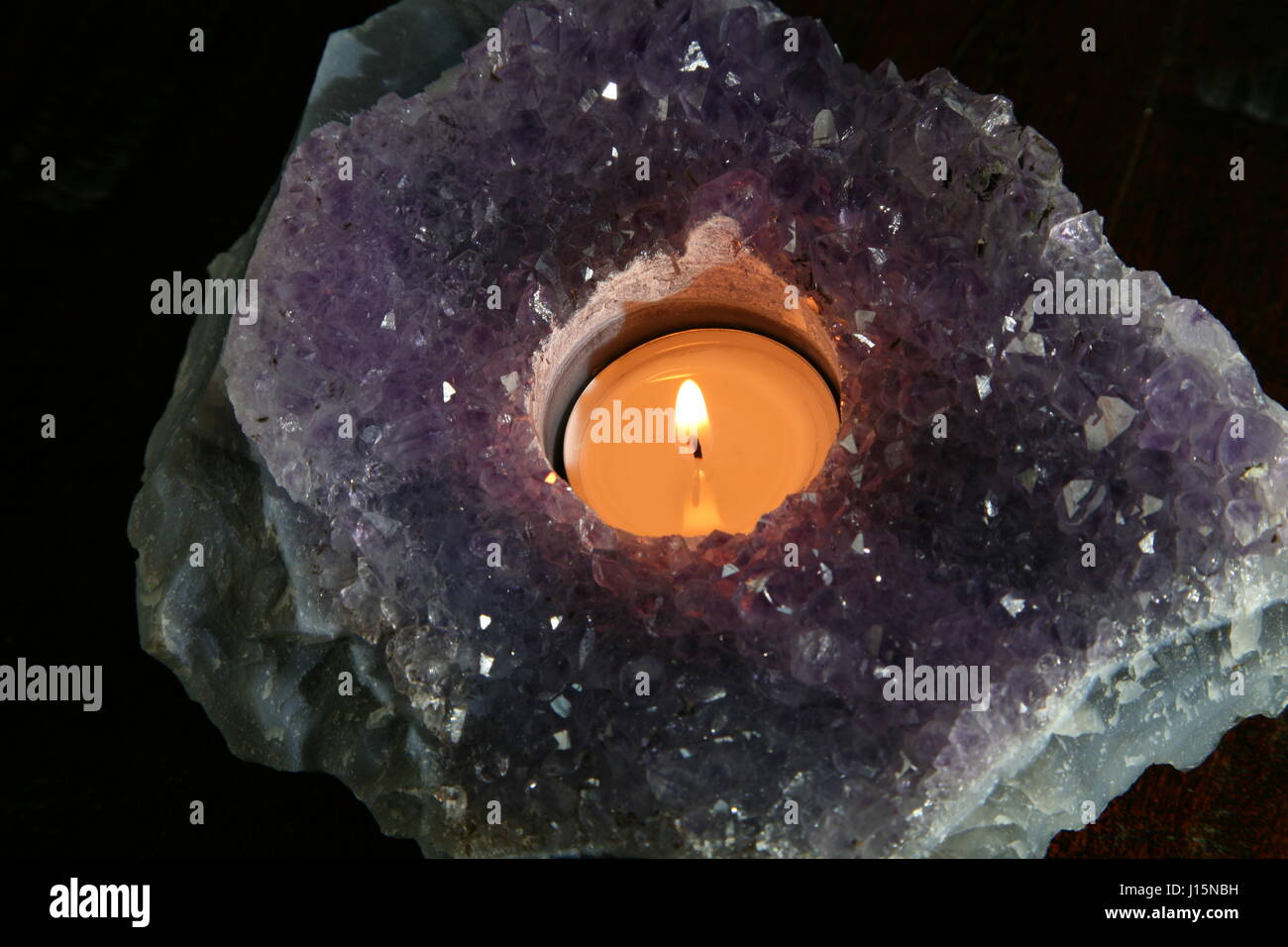 tea candle in amethyst geode Stock Photo Alamy