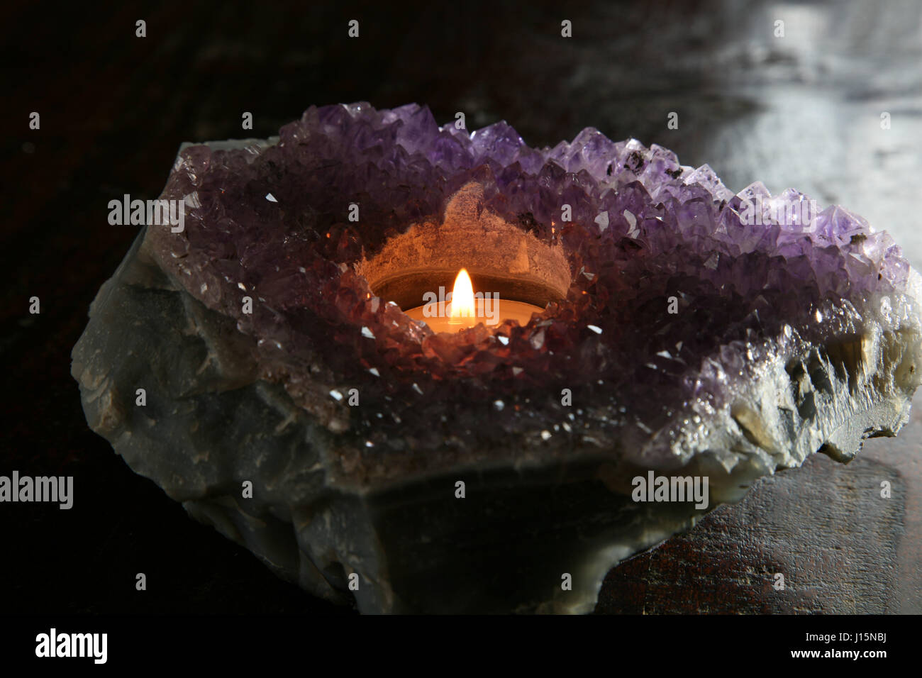 tea candle in amethyst geode Stock Photo Alamy