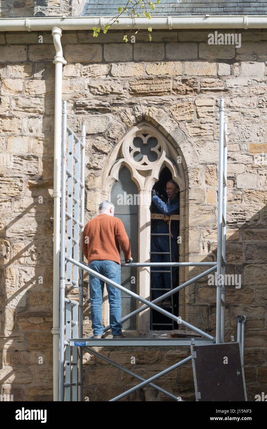 Stonemasons restoring window, Church of St Mary and St Cuthbert, Chester le Street, Co. Durham, England, UK Stock Photo