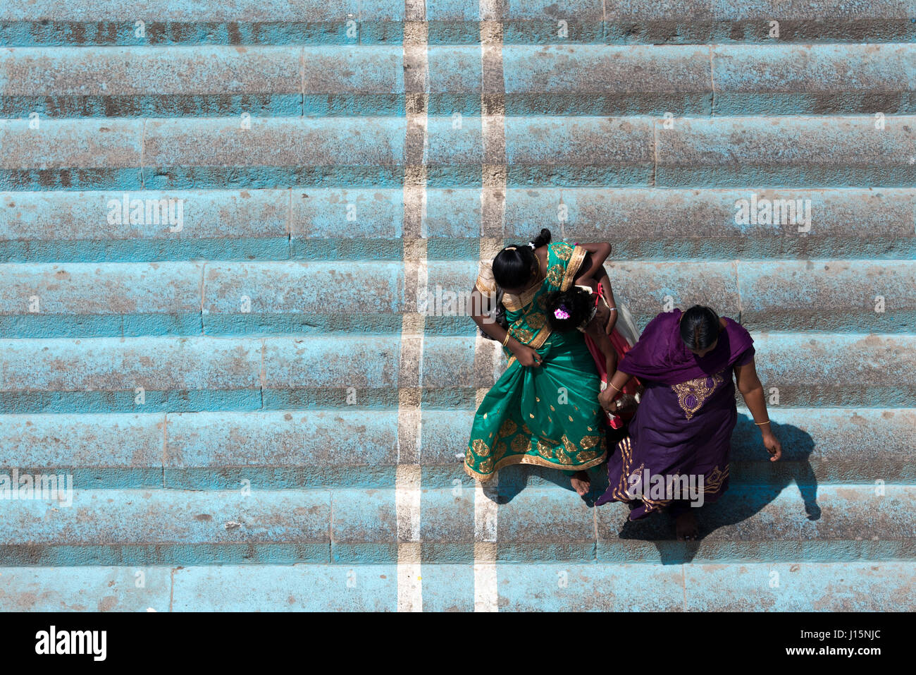 Two women dressed in saree descending staircase in Kanyakumari, India Stock Photo