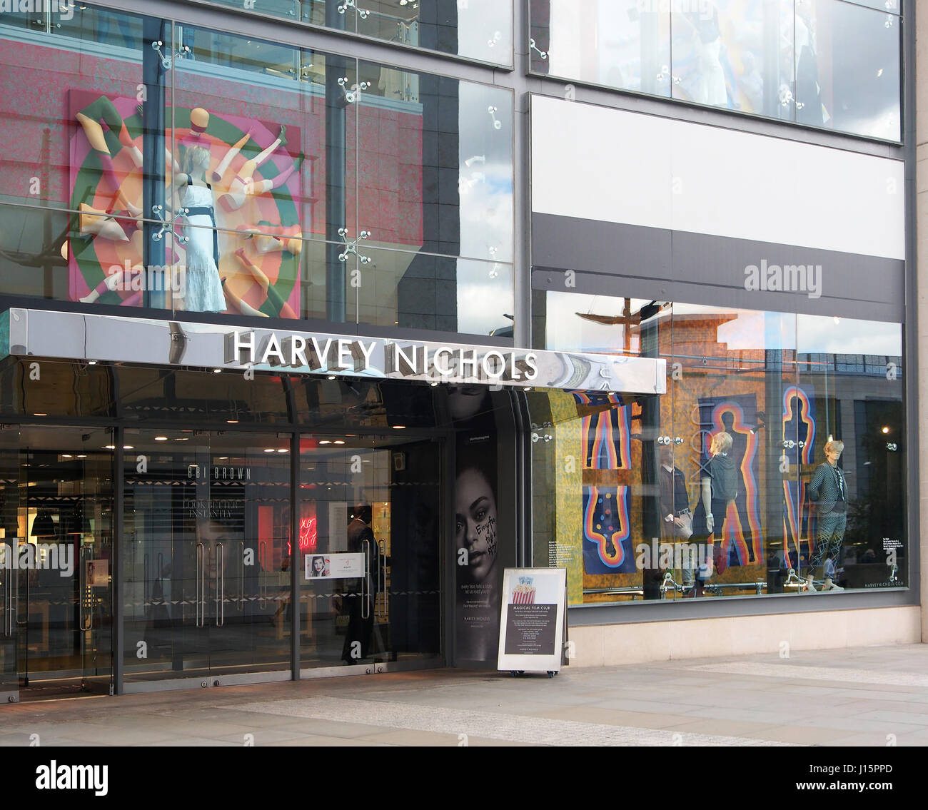 Exterior of the Harvey Nichols shop store in the city centre center of Manchester, England, UK, showing the colourful colorful window displays. Stock Photo