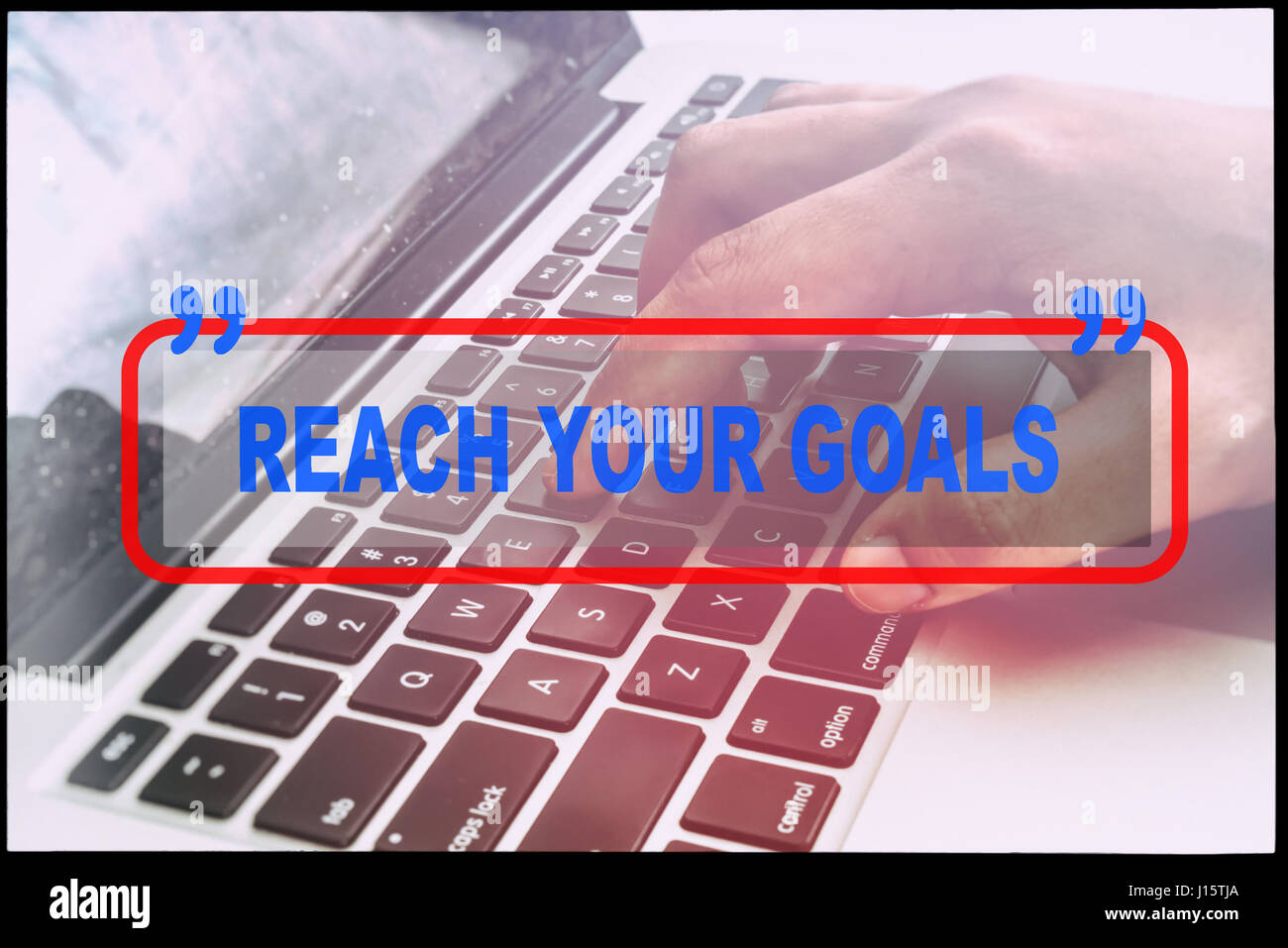 Hand and text "REACH YOUR GOALS" with vintage background. Technology ...