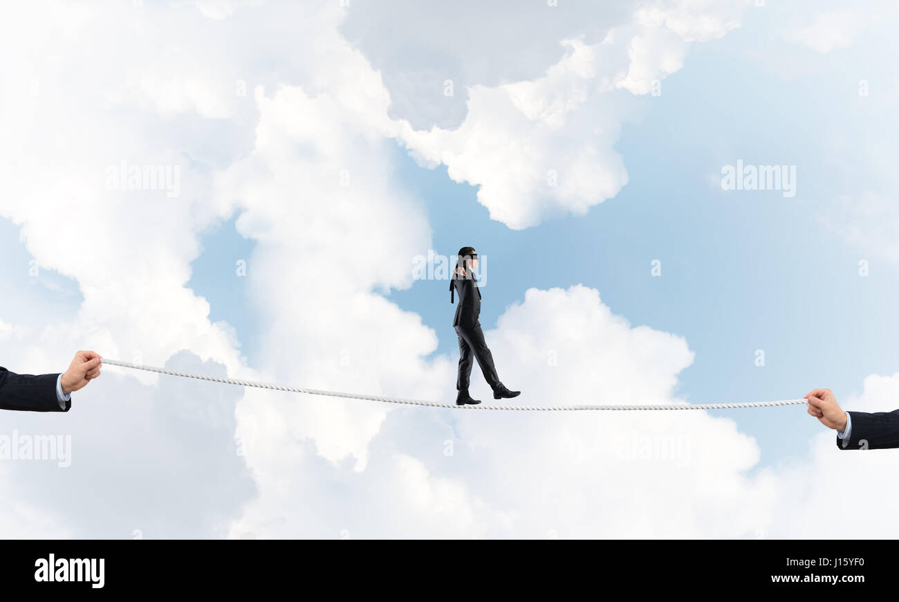 Business concept of risk support and assistance with man balancing on ...