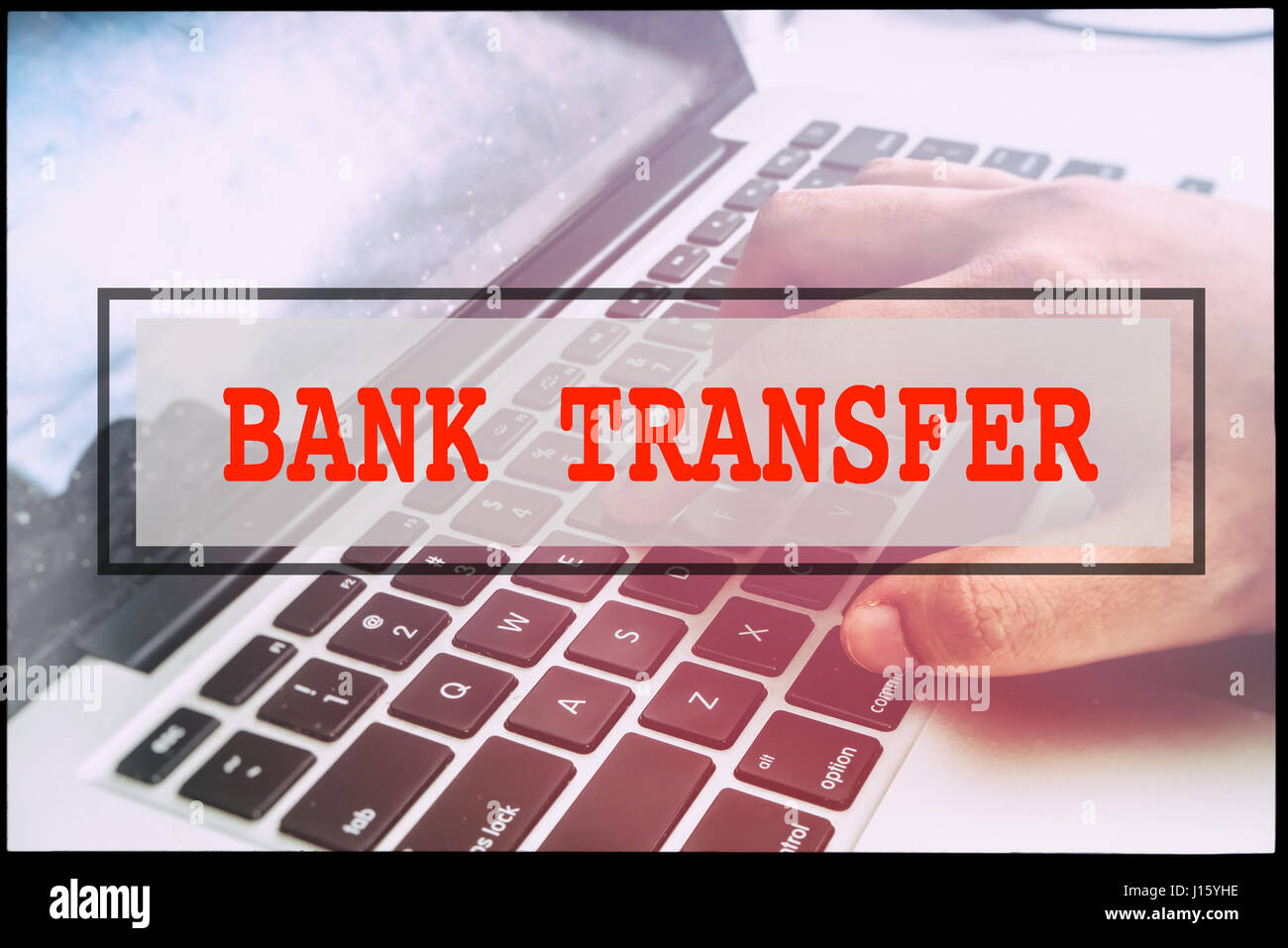 Hand and text BANK TRANSFER with vintage background. Technology concept ...