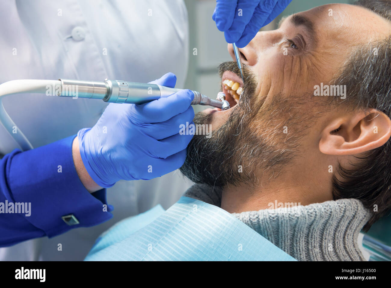 Dentist cleaning teeth. Hands of stomatologist with tools. Dental