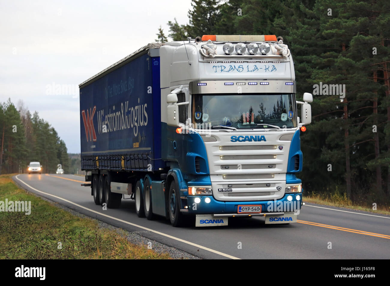 SALO, FINLAND - OCTOBER 30, 2016: Customized Scania R500 semi truck of Trans La-Ka hauls shipping trailer along rural road in South of Finland. Stock Photo