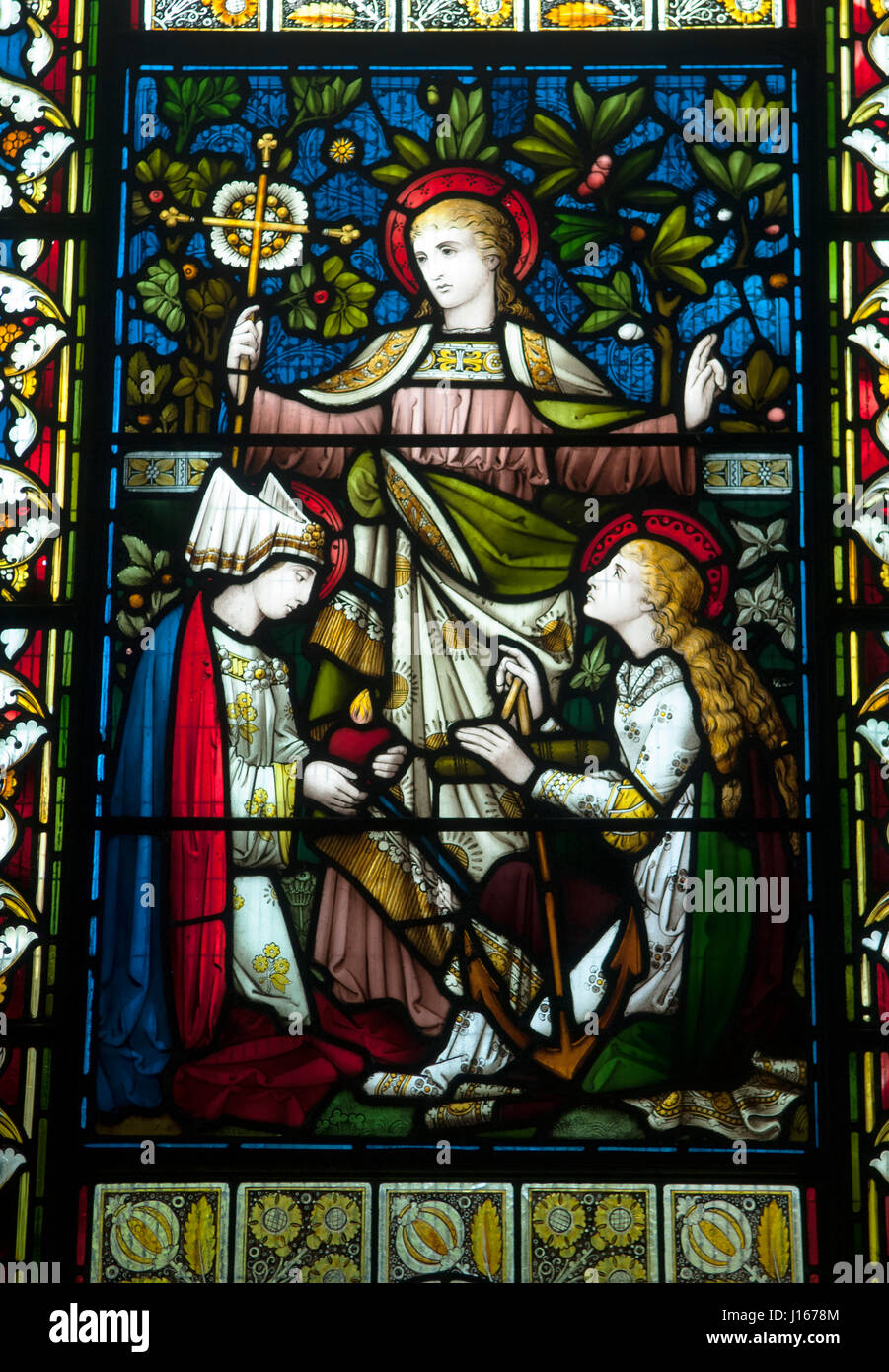 Faith Hope and Charity. A Cross a symbol of Faith. An anchor a symbol of Hope. A Heart a symbol of Charity or Love. Church of St Mary in Christon, North Somerset, England dates from the 12th century, the stained glass window.  HOMER SYKES Stock Photo