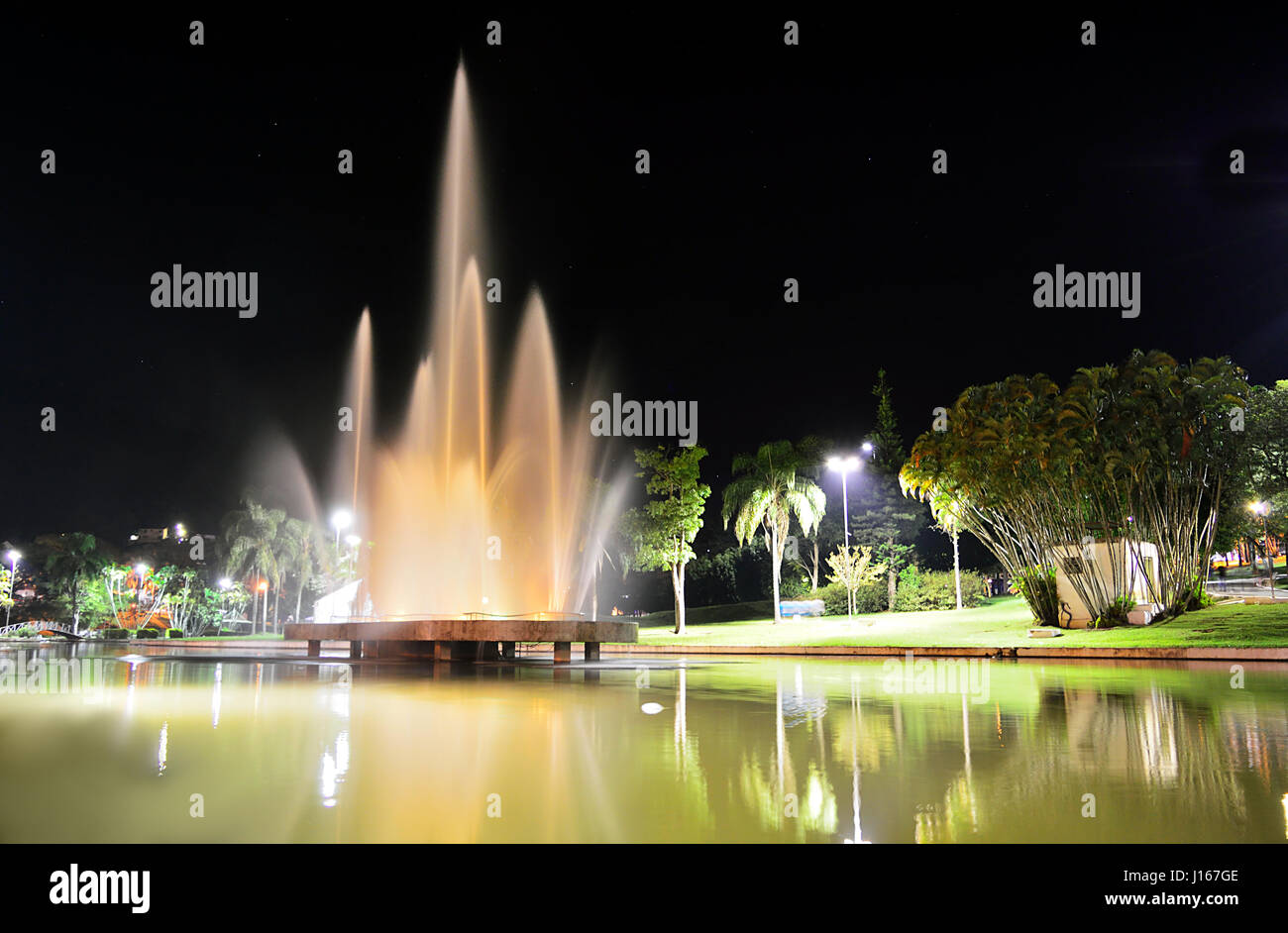 Water fountain illuminated at night Stock Photo - Alamy