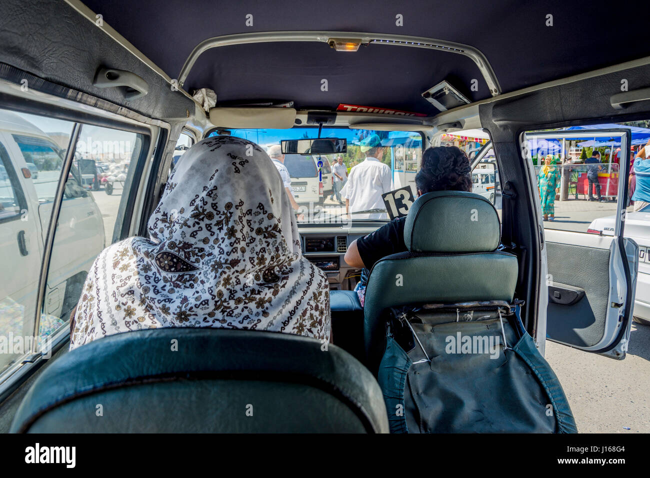 MARGILAN, UZBEKISTAN - AUGUST 20: First person view from the inside of Uzbek minibus called marshrutka. August 2016 Stock Photo