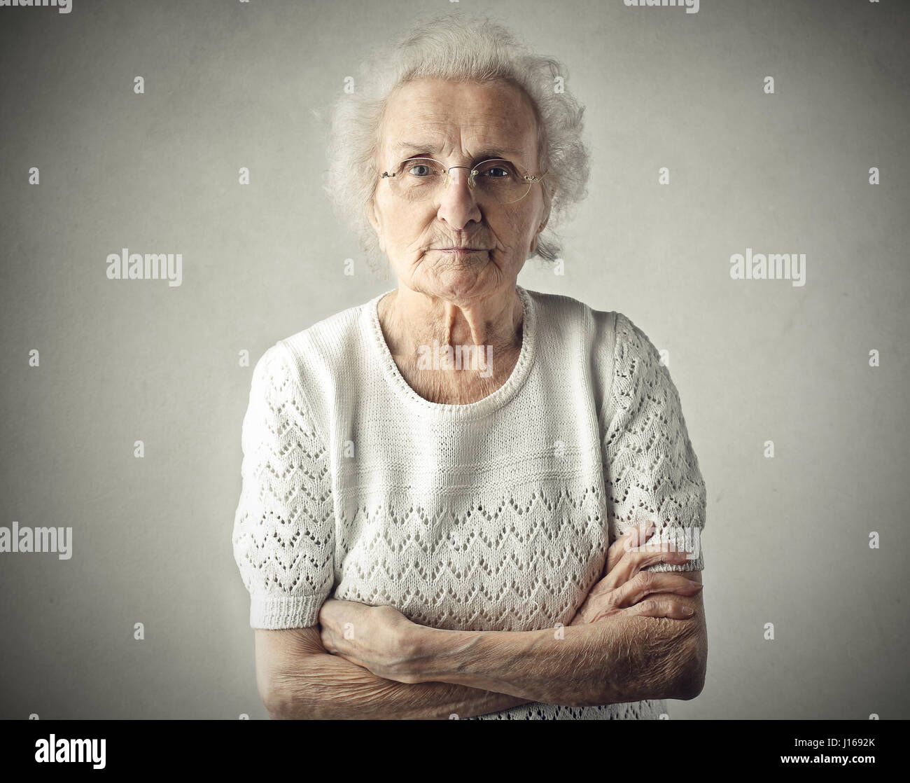 Old lady crossing her arms Stock Photo