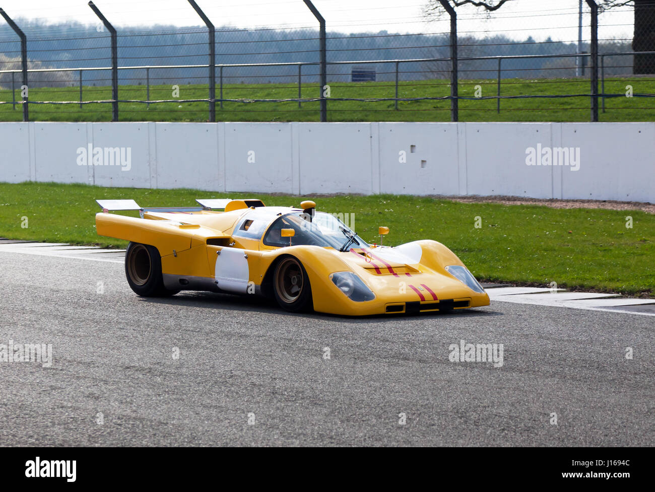 Front view of a very rare, yellow, 1970  Ferrari 512M, on the track ,during the Silverstone Classic Media Day, 2017 Stock Photo