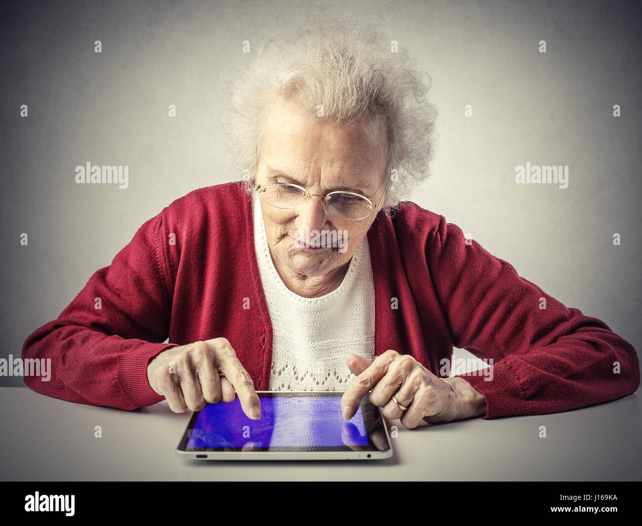 Old lady with tablet Stock Photo