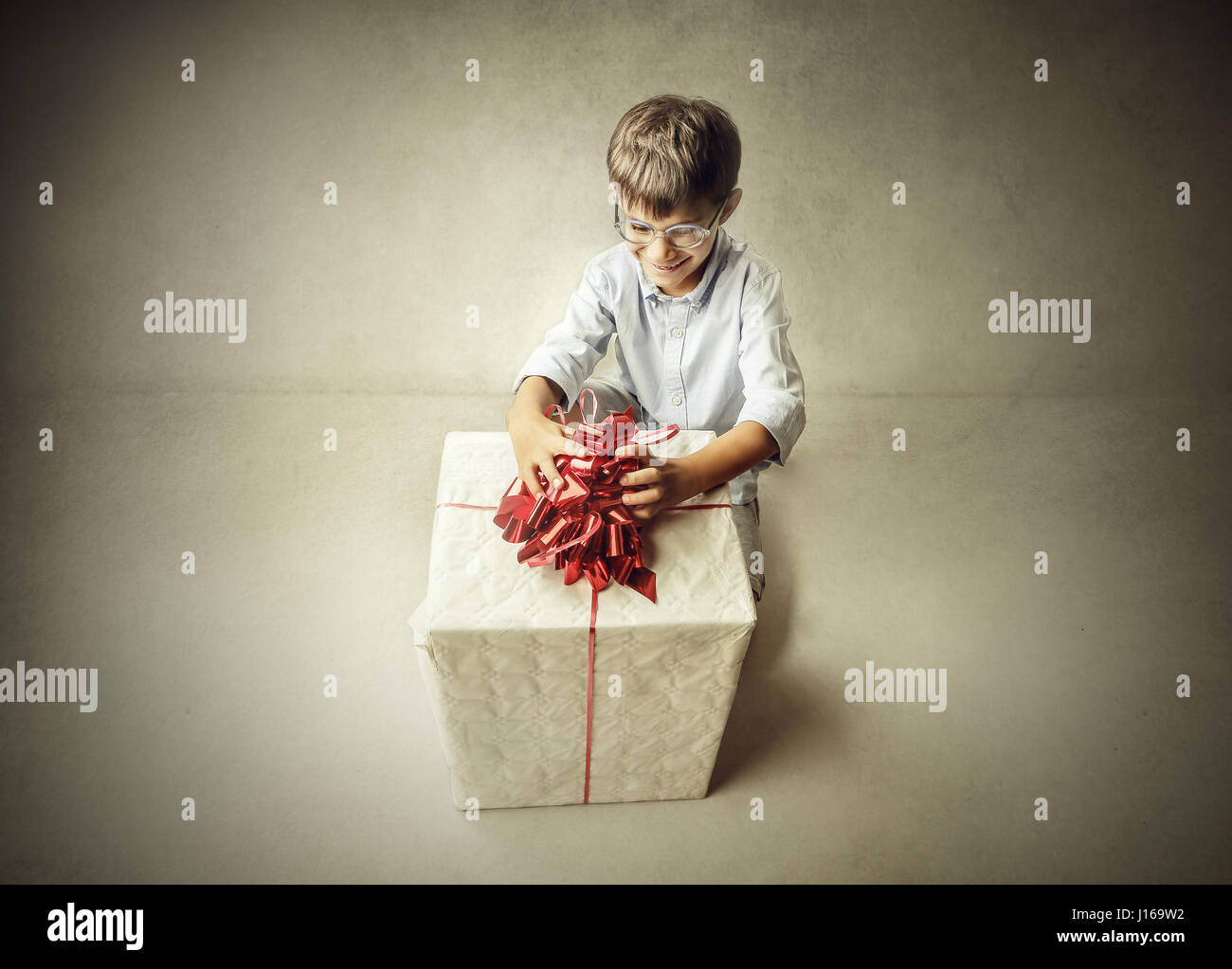 Little boy opening present Stock Photo