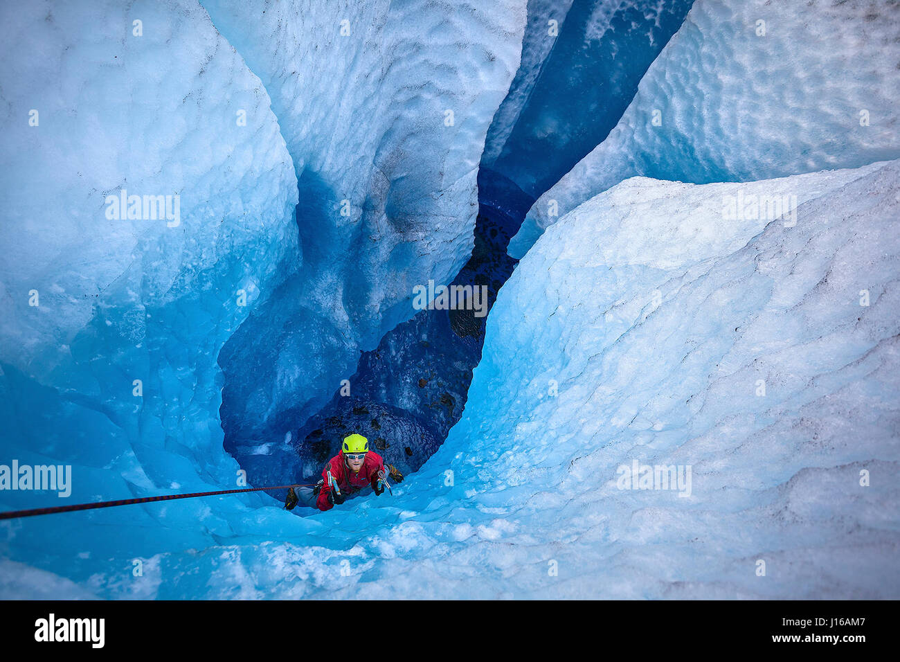 JUNEAU, ALASKA Guide Corey Denton uses ice axes to climb the maulin. A