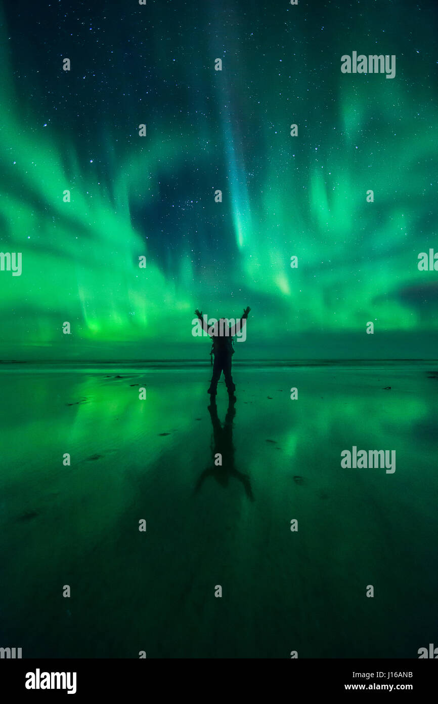 VARIOUS LOCATIONS, WORLDWIDE: A man takes in the glory of the Aurora as reflected in the sand, at a beach in Norway. FROM an incredibly colourful hot spring to basking in the glory of the stars these pictures show people simply awe-struck by the wonders of our world. One photographer made it his mission to travel the world to celebrate humanity enjoying the most incredible sights in the world – including eye-popping waterfalls, mysterious caverns, the spectacular Northern Lights and even Nevada’s famous Burning Man Festival. Hawaii-based Dustin Wong (31) explained how he came up with the idea  Stock Photo