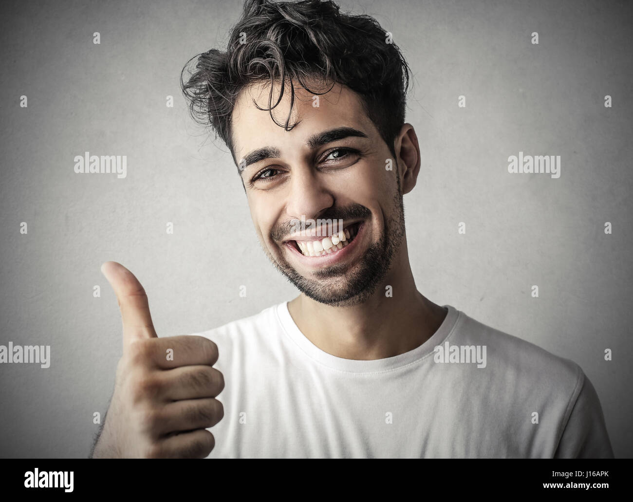 Handsome man making like sign Stock Photo
