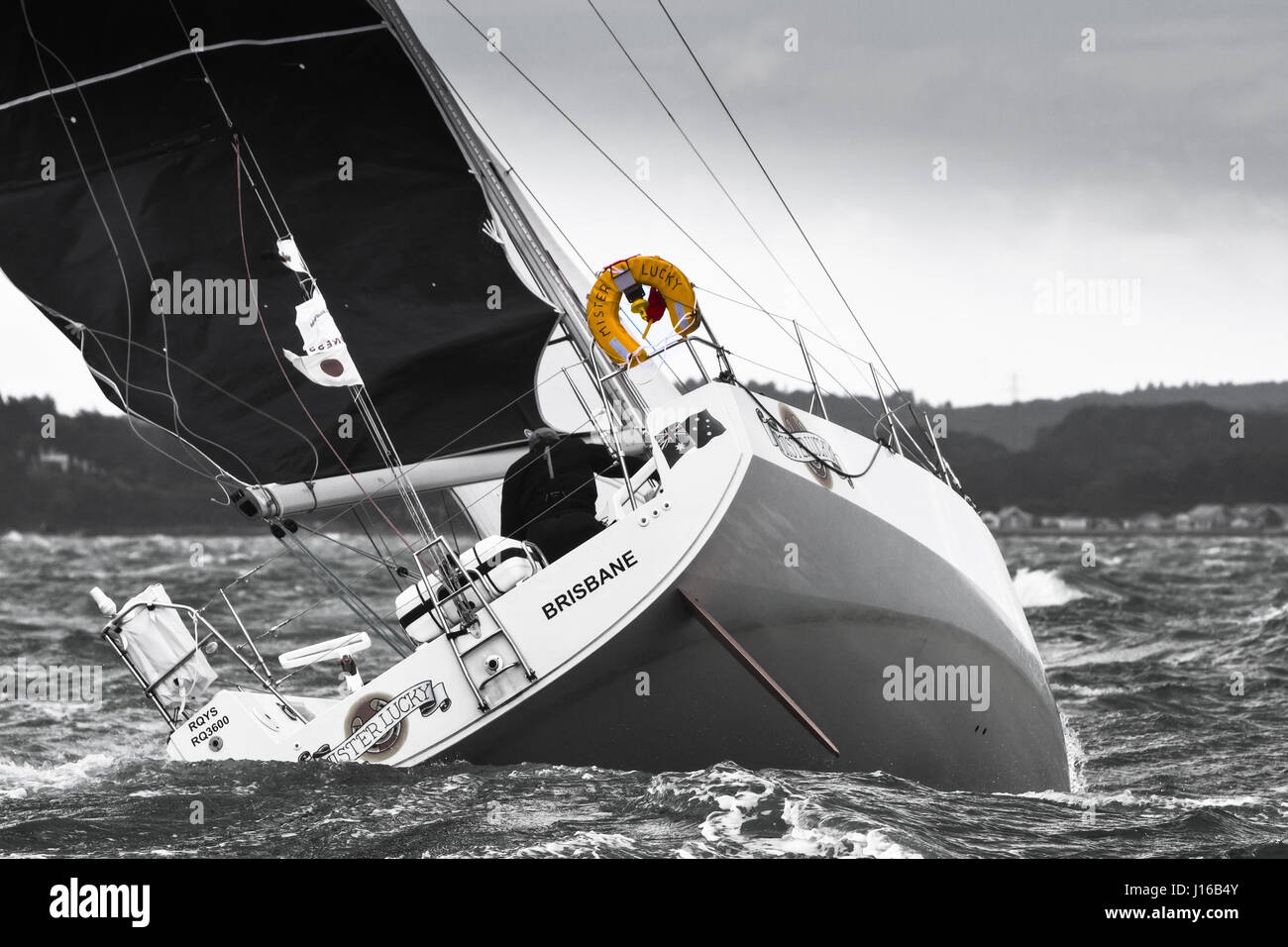 Yacht racing in the Solent (UK)(SORC) Black and White with colour Buoyancy Aid Stock Photo