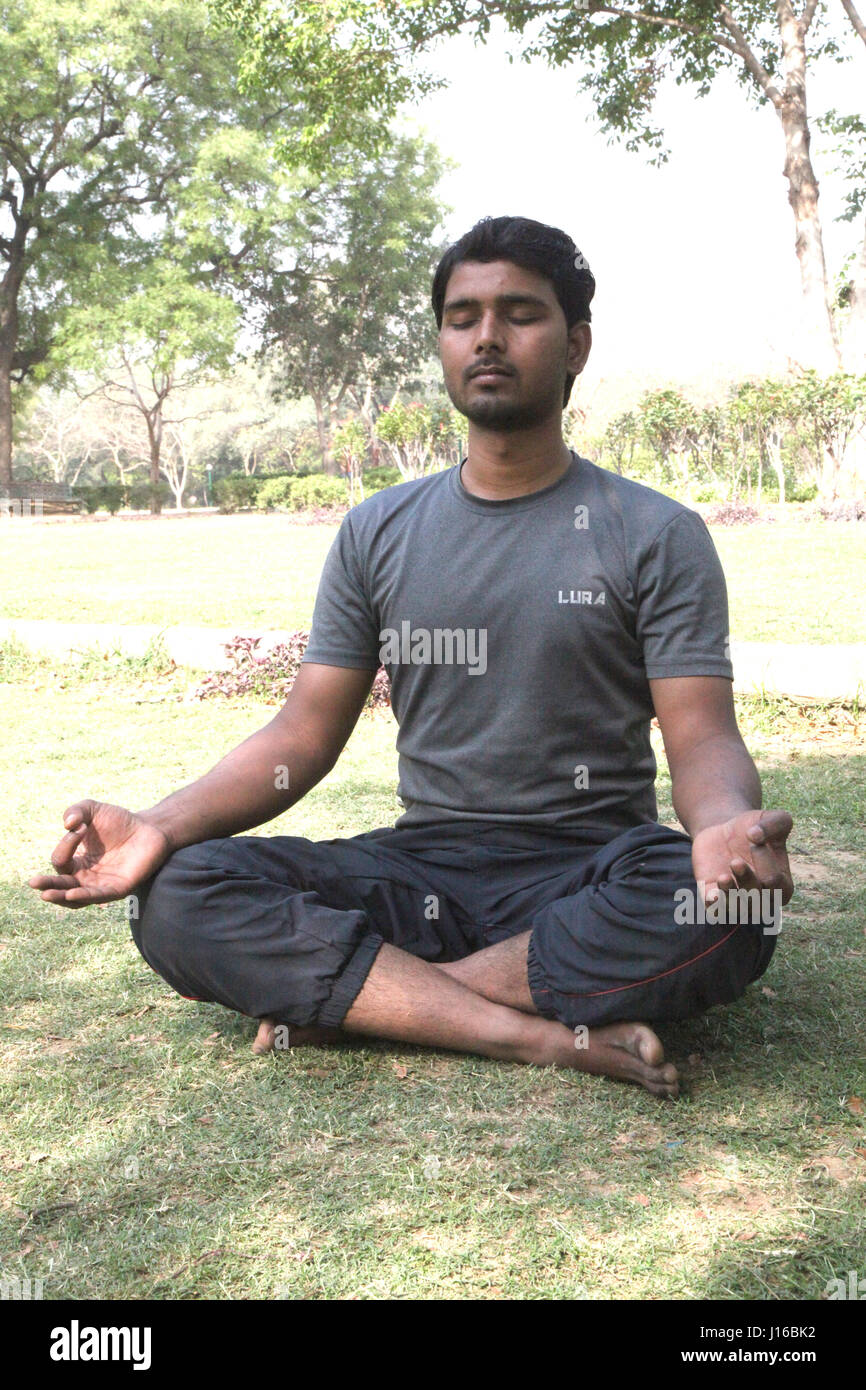 In childrens park, Young Man Practicing Yoga, Meditation, Morning Garden, New Delhi, India, (Photo Copyright © by Saji Maramon) Stock Photo