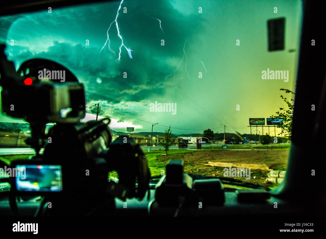 A JAW-DROPPING picture of what looks like a pink lightning bolt looping through the stormy sky and striking the Earth has been captured by an off-duty cameraman. The bolt appears to defy gravity itself by passing upwards before changing direction towards the ground. Other pictures taken by the amateur stormchaser shows in-car pictures of the gathering super-cell storm as it is pursued across the countryside, which can be seen being punished by high-winds. Australian film and TV cameraman Rick Smart (35) from Melbourne described the moment took the incredible shot while resting in a car park in Stock Photo