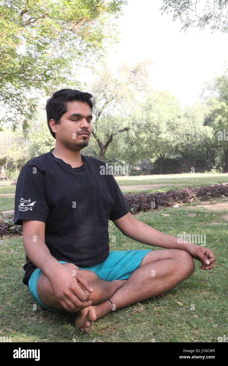 Young man meditation in the morning, Meditation, Yoga, Morning Garden, New Delhi, India, (Photo Copyright © by Saji Maramon) Stock Photo