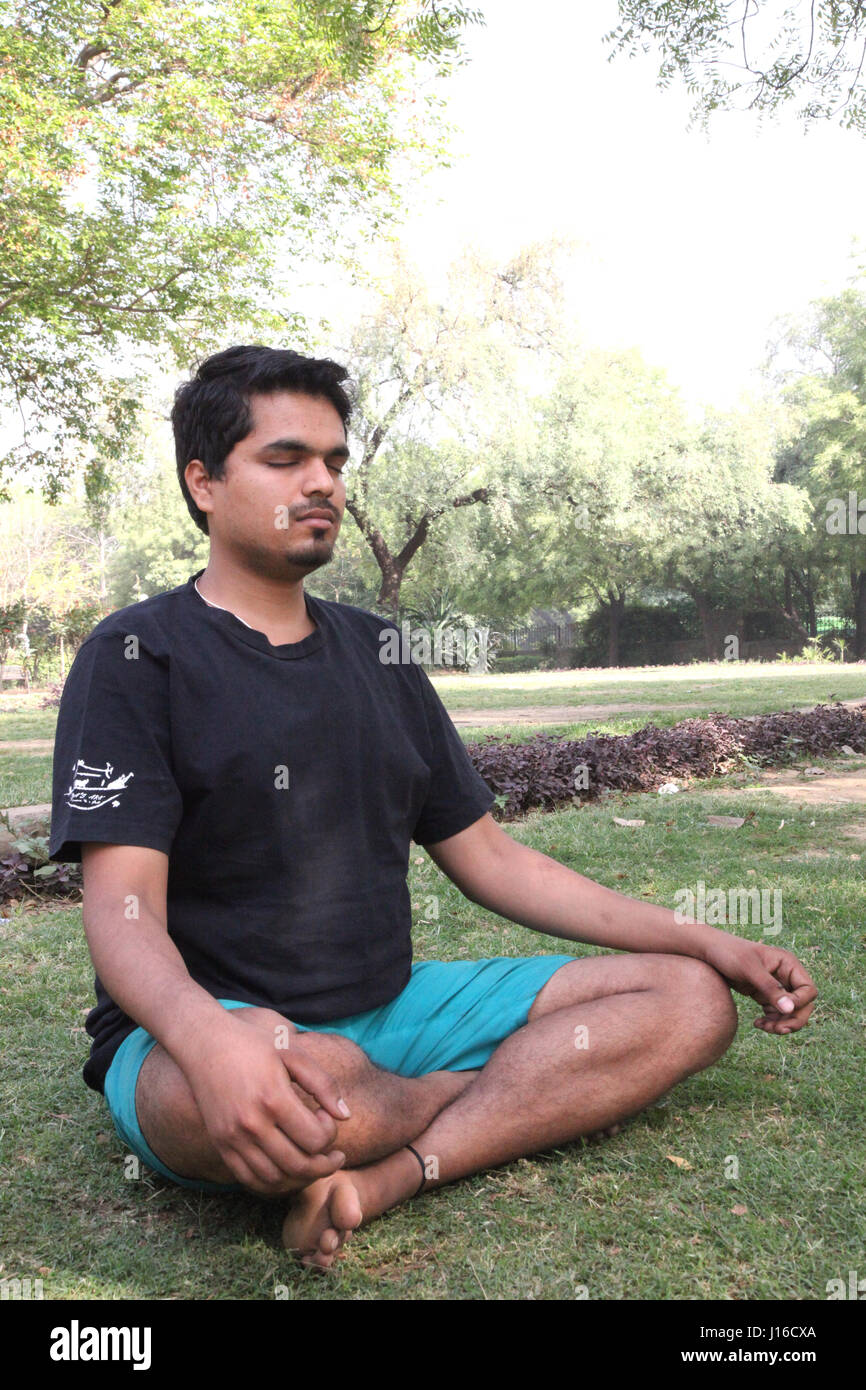 Young man meditation in the morning, Meditation, Yoga, Morning Garden, New Delhi, India, (Photo Copyright © by Saji Maramon) Stock Photo