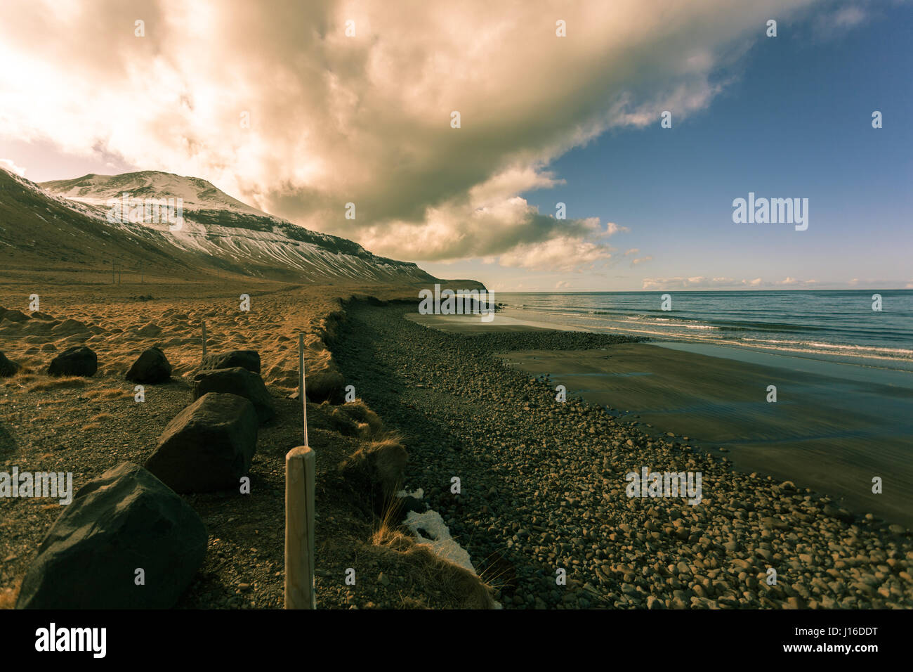 Sunset over a black sand beach on the north coast of the Snæfellsnes ...