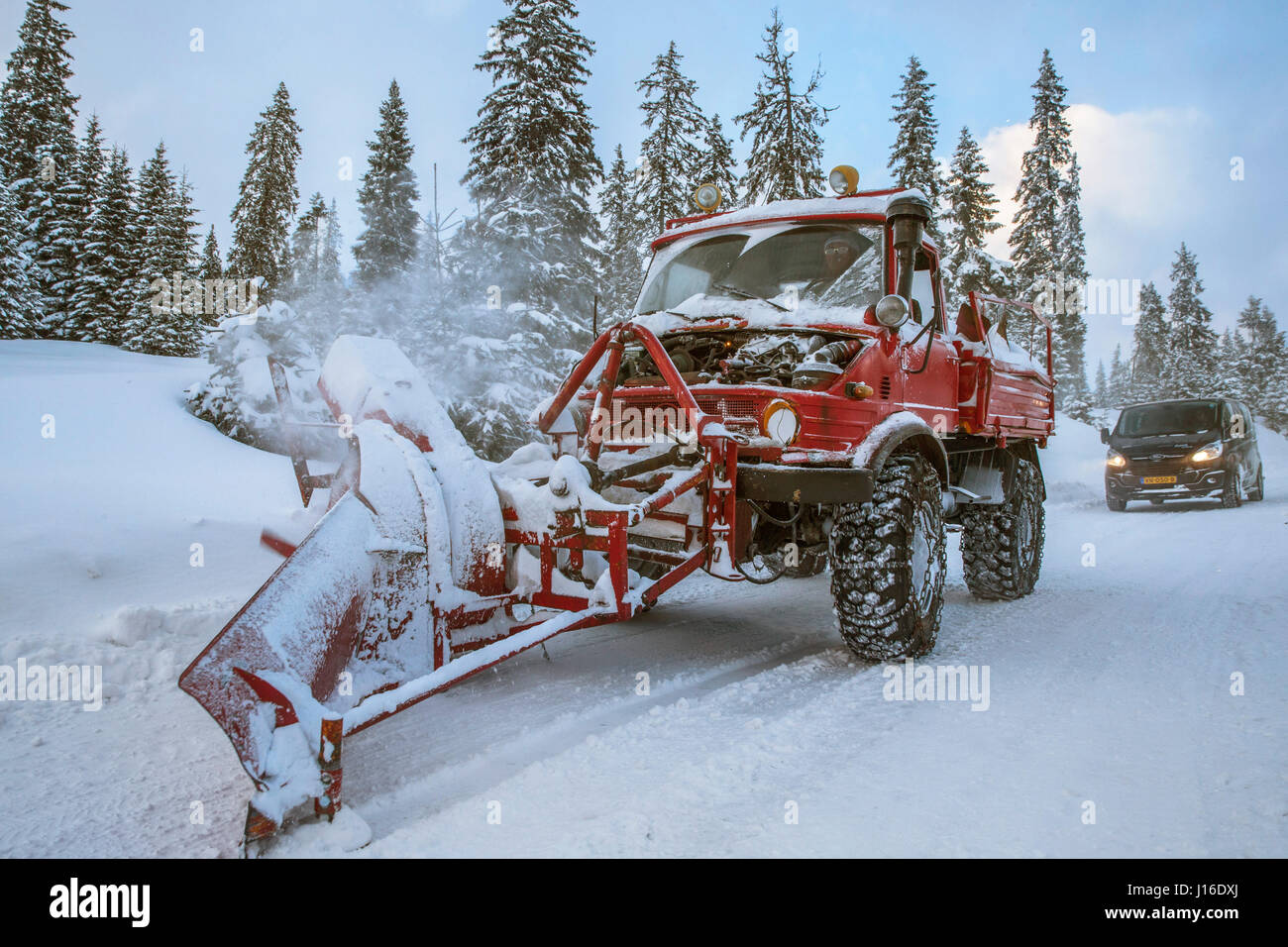 Big old snow plough clearing road after snow storm in Romania Stock Photo