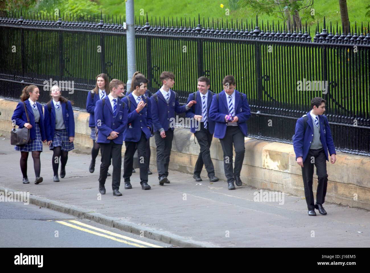 British school children on street messing about walking home from school the high school of Glasgow Stock Photo